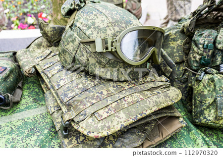 Army kevlar helmet to protect the head from bullets and shrapnel with protective goggles 112970320