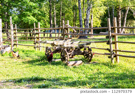 Vintage wooden cart without a horse at the field in sunny summer day 112970379