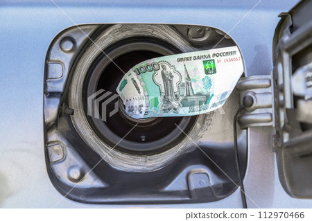 Russian rubles banknotes in the gas tank of a vehicle 112970466