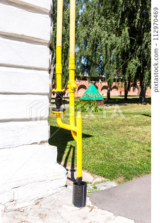 Gas entry point to a residential building. Gas pipes with valve on the building wall Gas entry point to a residential building. Gas pipes with valve on the building wall 112970469