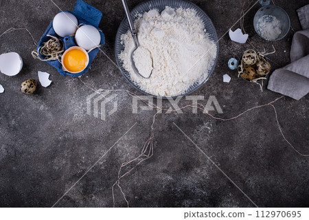 Baking ingredients with flour and eggs Baking ingredients with flour and eggs 112970695