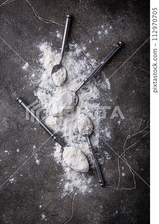 Wheat flour on dark. Baking background 112970705