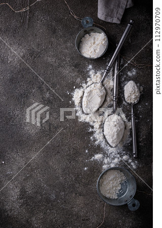 Wheat flour on dark. Baking background 112970709