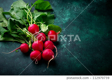 Fresh organic radish on green background 112970739