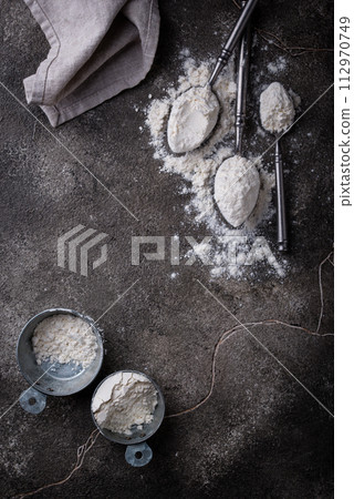 Wheat flour on dark. Baking background Wheat flour on dark. Baking background 112970749