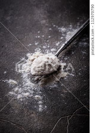 Wheat flour on dark. Baking background Wheat flour on dark. Baking background 112970790