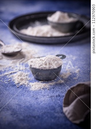 Wheat flour on dark. Baking background 112970903