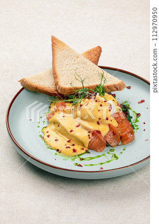 Egg benedict with salmon and toasts Egg benedict with salmon and toasts 112970950