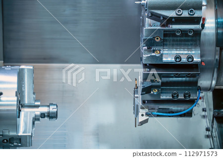 The CNC lathe machine forming cutting the metal parts. hi-technology metal working by CNC turning 112971573