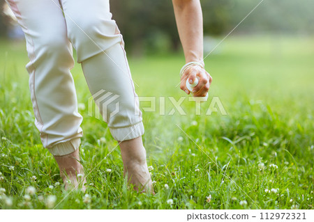 Closeup on woman with repellent spray 112972321