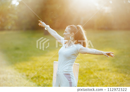 smiling elegant woman in white shirt in meadow outdoors 112972322