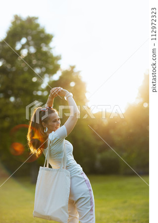 cheerful modern female in white shirt with tote bag cheerful modern female in white shirt with tote bag 112972323