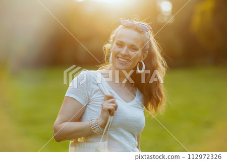 Portrait of happy trendy female in white shirt Portrait of happy trendy female in white shirt 112972326