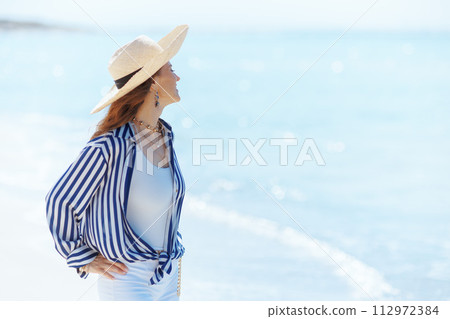 relaxed stylish woman on seacoast enjoying peace of mind relaxed stylish woman on seacoast enjoying peace of mind 112972384