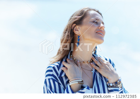 relaxed stylish woman on ocean coast enjoying peace of mind relaxed stylish woman on ocean coast enjoying peace of mind 112972385