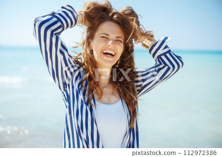 happy elegant female on beach having fun time 112972386