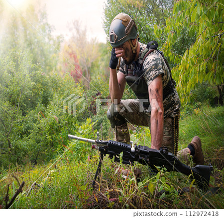 A soldier in the grass pray God 112972418