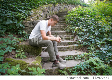 Sad man sitting on the stairs Sad man sitting on the stairs 112972437
