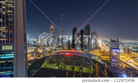 Dubai downtown skyline night timelapse with tallest building and Sheikh Zayed road traffic, UAE Dubai downtown skyline night timelapse with tallest building and Sheikh Zayed road traffic, UAE 112972456