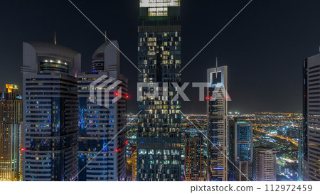 Skyline view of the buildings of Sheikh Zayed Road and DIFC night timelapse in Dubai, UAE. 112972459