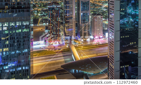 Skyline view of the buildings of Sheikh Zayed Road and DIFC night timelapse in Dubai, UAE. 112972460