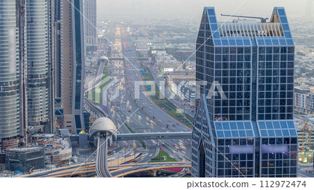 Dubai downtown skyline day to night timelapse and Sheikh Zayed road traffic, UAE Dubai downtown skyline day to night timelapse and Sheikh Zayed road traffic, UAE 112972474
