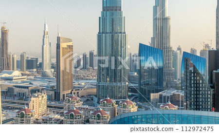 Dubai downtown skyline at sunset timelapse with tallest building and Sheikh Zayed road traffic, UAE 112972475