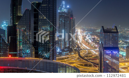 Dubai downtown skyline night timelapse and Sheikh Zayed road traffic, UAE 112972481
