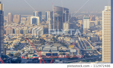 Skyline view of the buildings of Sheikh Zayed Road and DIFC timelapse in Dubai, UAE. 112972486