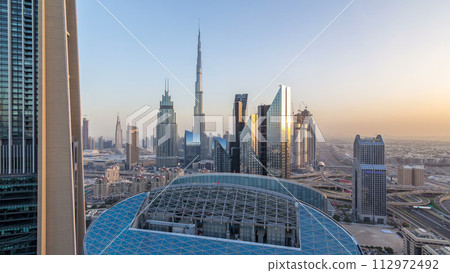 Dubai downtown skyline day to night timelapse with tallest building and Sheikh Zayed road traffic, UAE Dubai downtown skyline day to night timelapse with tallest building and Sheikh Zayed road traffic, UAE 112972492