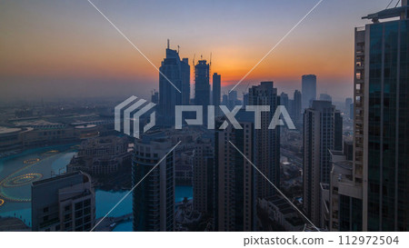 Foggy morning sunrise in downtown of Dubai timelapse. Foggy morning sunrise in downtown of Dubai timelapse. 112972504
