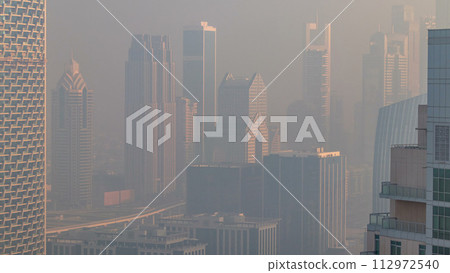 Foggy morning in downtown of Dubai timelapse. 112972540