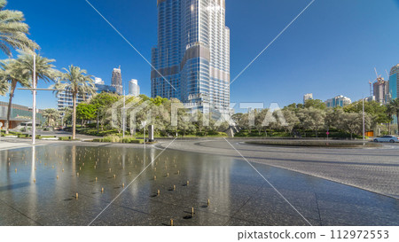 Fountains near main entrance to the tallest skyscraper timelapse hyperlapse, Dubai 112972553