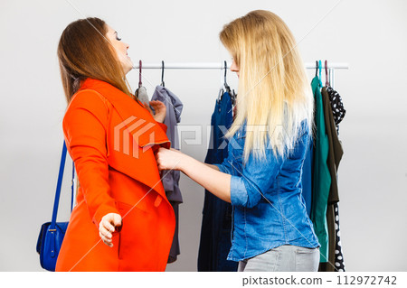 Two women on clothes shopping Two women on clothes shopping 112972742