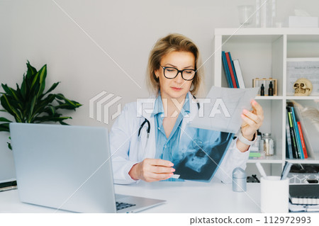 Female doctor makes online video call consult patient on laptop. Middle aged woman therapist videoconferencing for domestic health treatment. Telemedicine concept. Online remote medical appointment. 112972993