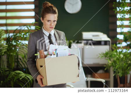 concerned 40 years old woman employee in green office 112973164