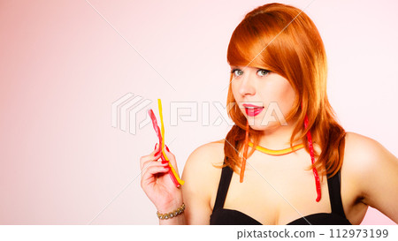 Woman with lot of sweets. 112973199