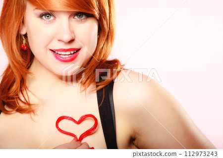 Girl holding valentine red heart love symbol. Valentines day. 112973243