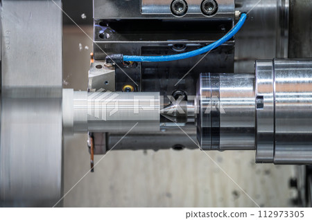 The CNC lathe machine forming cutting the metal parts. hi-technology metal working by CNC turning The CNC lathe machine forming cutting the metal parts. hi-technology metal working by CNC turning 112973305