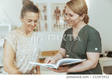 happy female massage therapist conduct educational training happy female massage therapist conduct educational training 112973412
