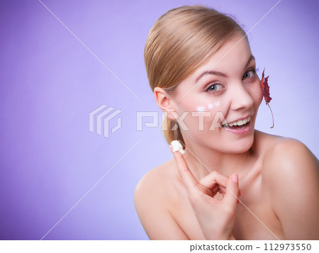 Skin care. Face of young woman girl with red maple leaf. 112973550