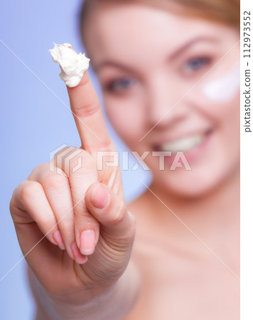 Skin care. Girl applying moisturizing cream. 112973552