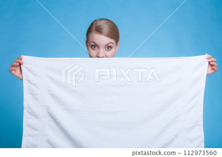 Woman hiding behind big white clean towel 112973560