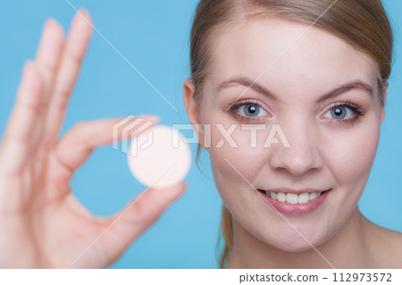 Woman hand holding big effervescent pill Woman hand holding big effervescent pill 112973572