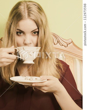 Woman drinking hot coffee beverage. Caffeine. 112973598