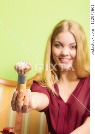 Attractive woman holding powder brush. Make up. 112973601