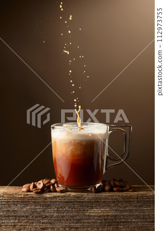 Coffee and chocolate drink with cream on a brown background. Coffee and chocolate drink with cream on a brown background. 112973755