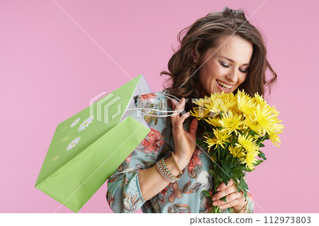 happy modern woman with long wavy brunette hair on pink 112973803