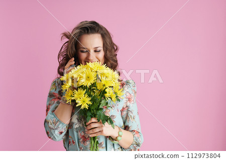 smiling trendy woman using smartphone on pink 112973804