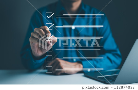 Businessman using pen to tick correct sign mark in checkbox for quality document control checklist and business approve project concept. Check mark, Filling out digital form checklist, Online exam, Businessman using pen to tick correct sign mark in checkbox for quality document control checklist and business approve project concept. Check mark, Filling out digital form checklist, Online exam, 112974052